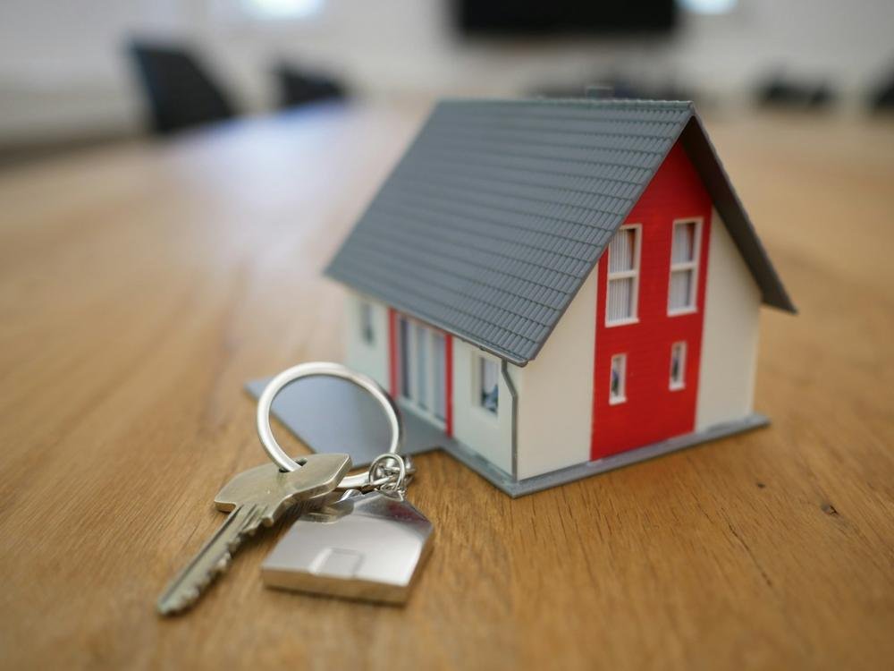 Small model house with keys on a table