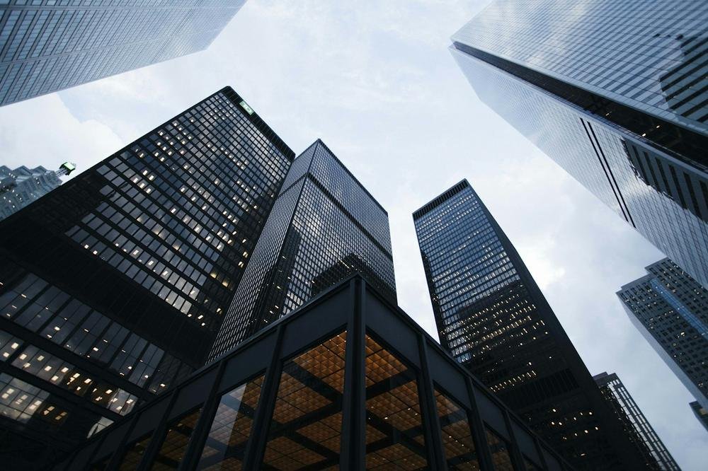 Tall glass office towers seen from below
